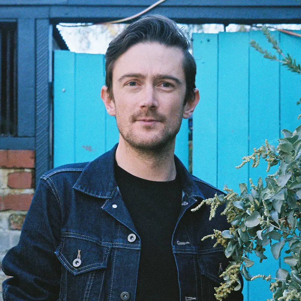 Photo of Go Modern Creative director Dan Beard against a blue wall